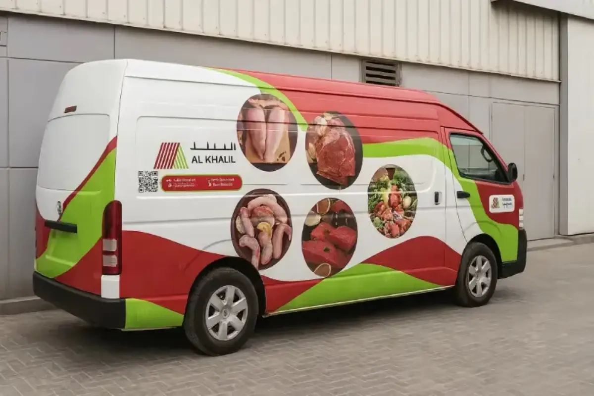Al Khalil partial branding with food graphics on a delivery van in Abu Dhabi