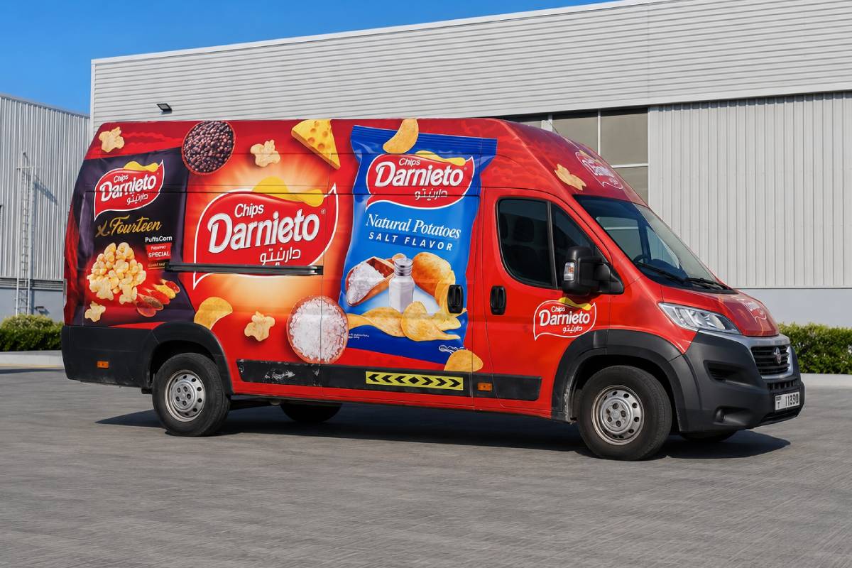 Chips Darnieto full vehicle branding on a red delivery van in Abu Dhabi