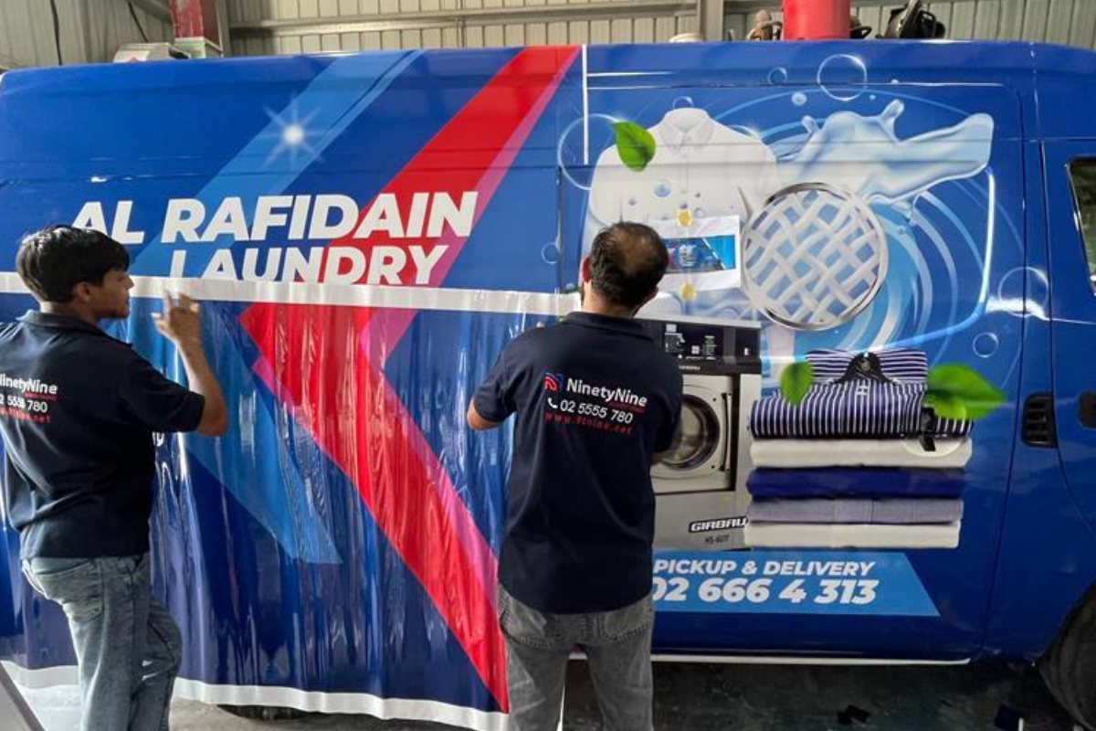 Full vehicle wrap being installed on an Al Rafidain Laundry van in our Abu Dhabi workshop