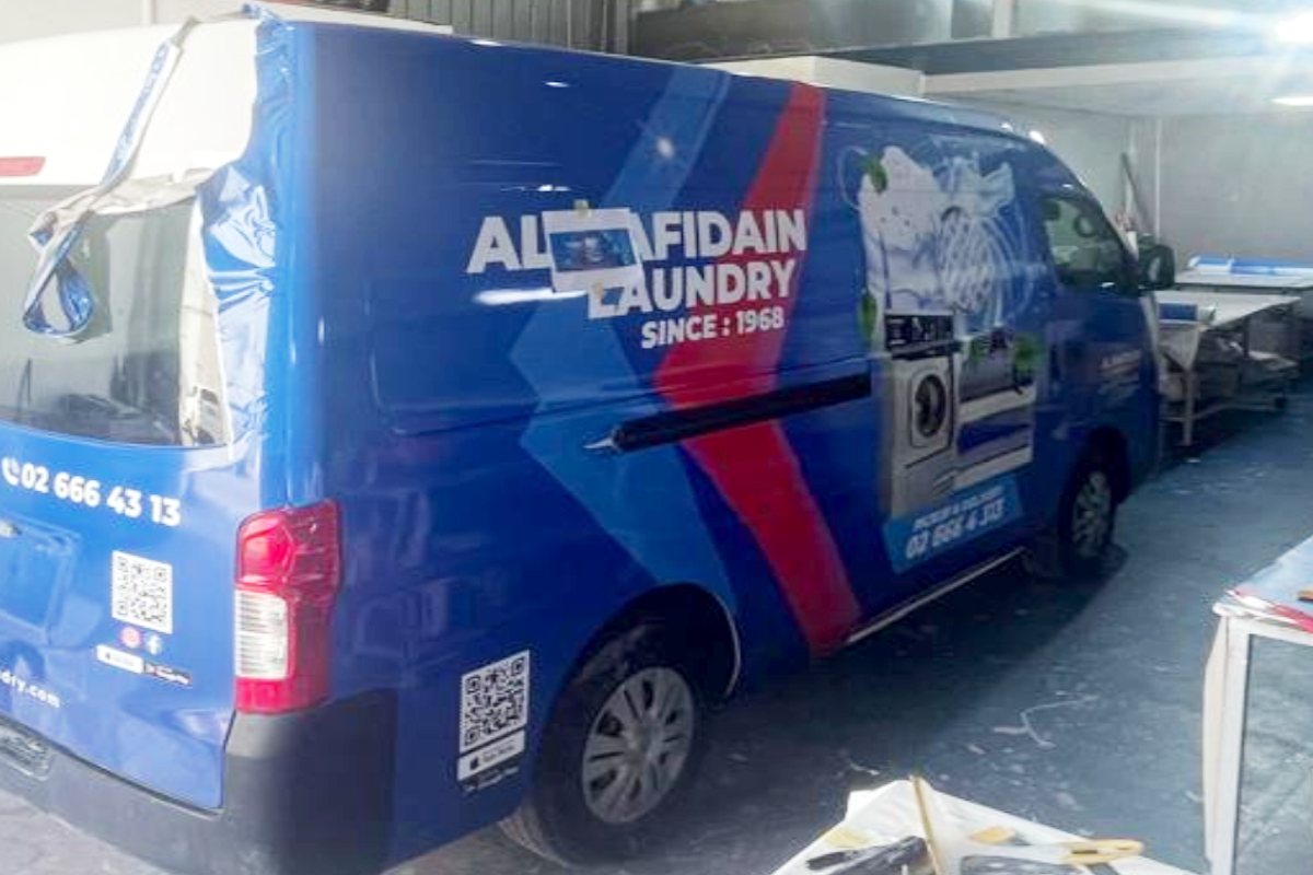 Full-body vinyl branding on Al Rafidain Laundry delivery vans in Abu Dhabi