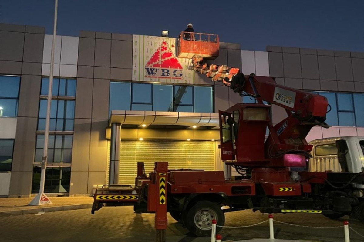 installation process at night building signage