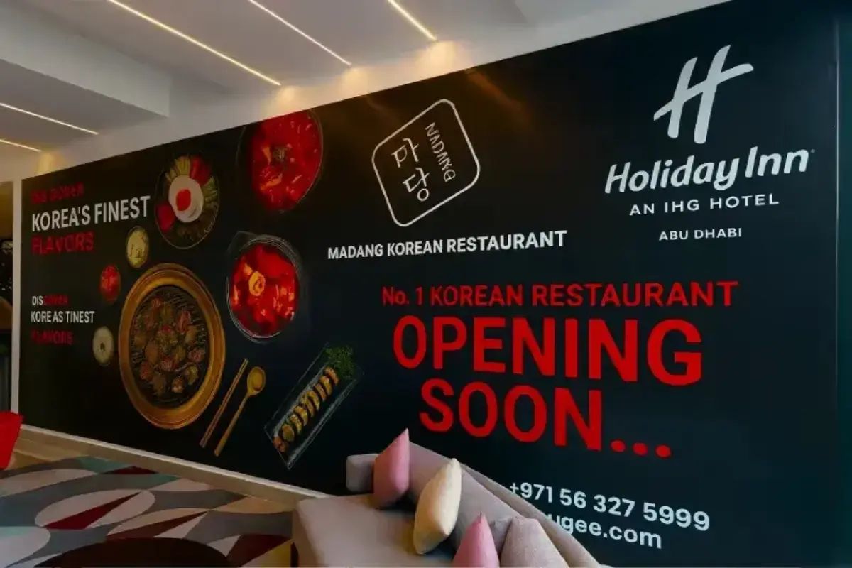 "Coming Soon" Red and Blue Retail Hoarding covering a shopfront on Yas Island, Abu Dhabi by Ninety Nine Advertising LLC.