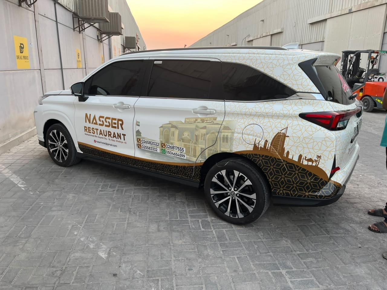 Nasser Restaurant full vehicle branding on a white Toyota in Abu Dhabi