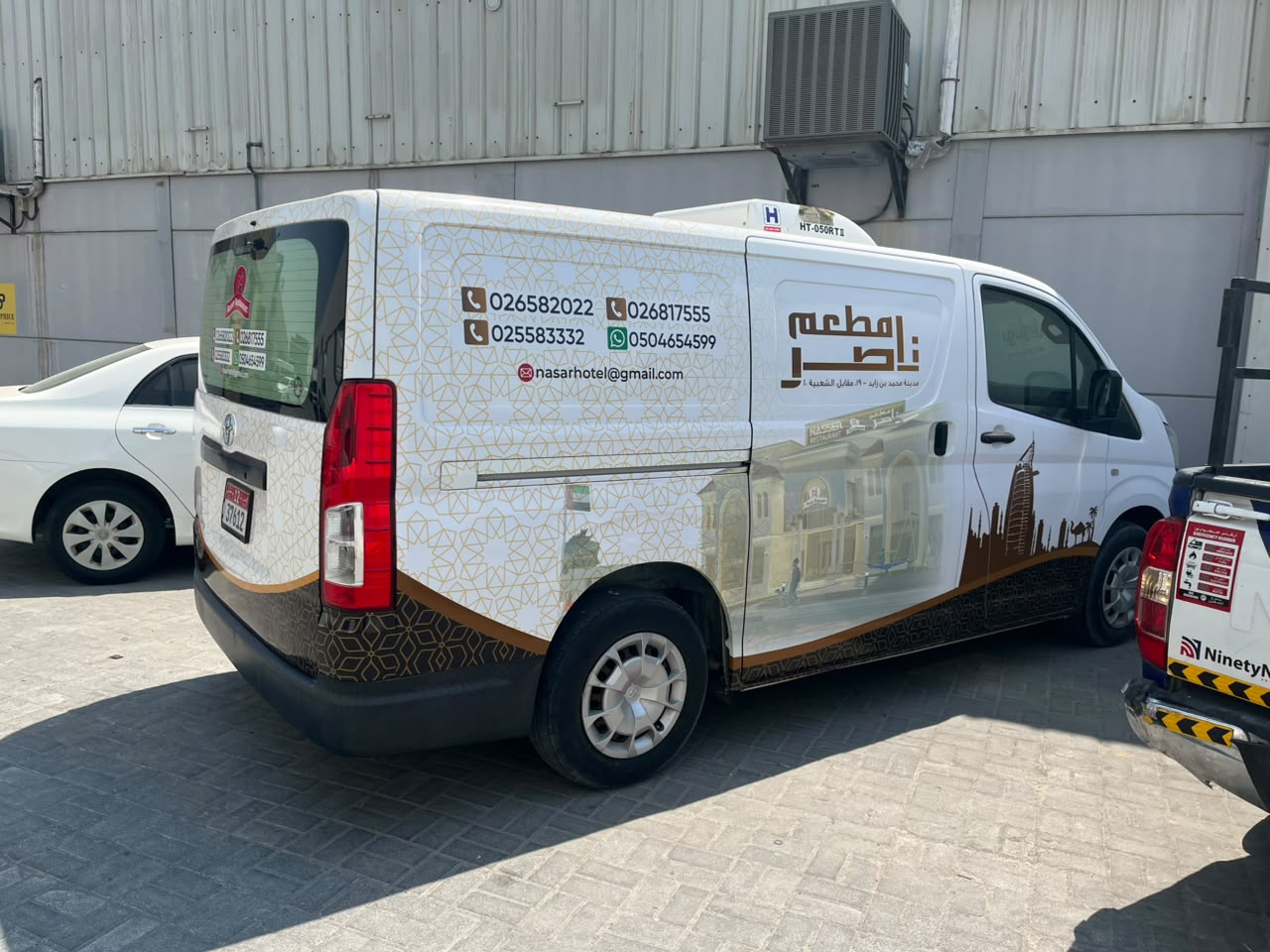 Nasser Restaurant Toyota refrigerated van with Arabic branding, right rear quarter