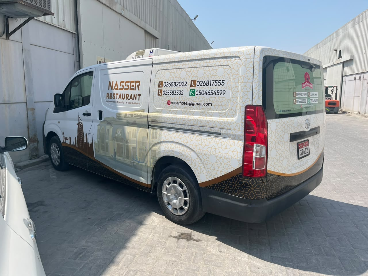 Nasser Restaurant Toyota refrigerated van with English branding, left rear quarter