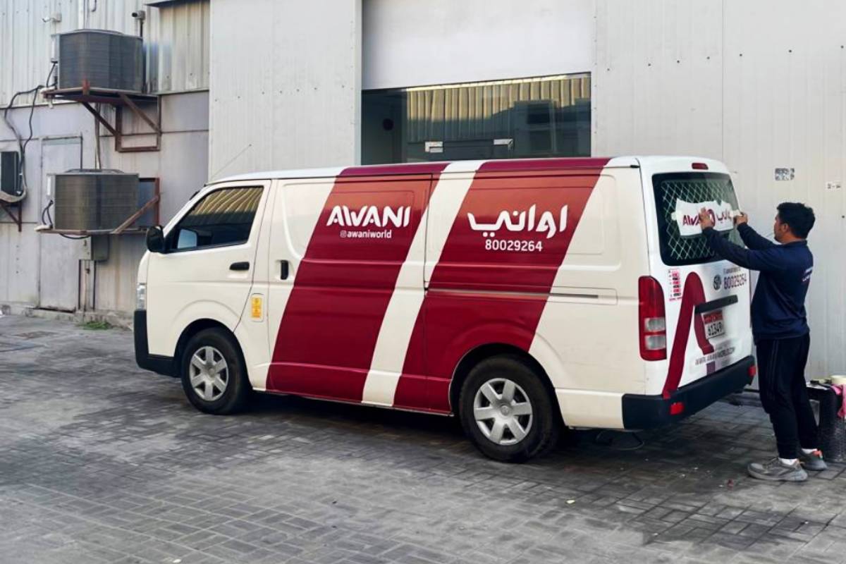 Partial van branding with red panels on a white van in Abu Dhabi
