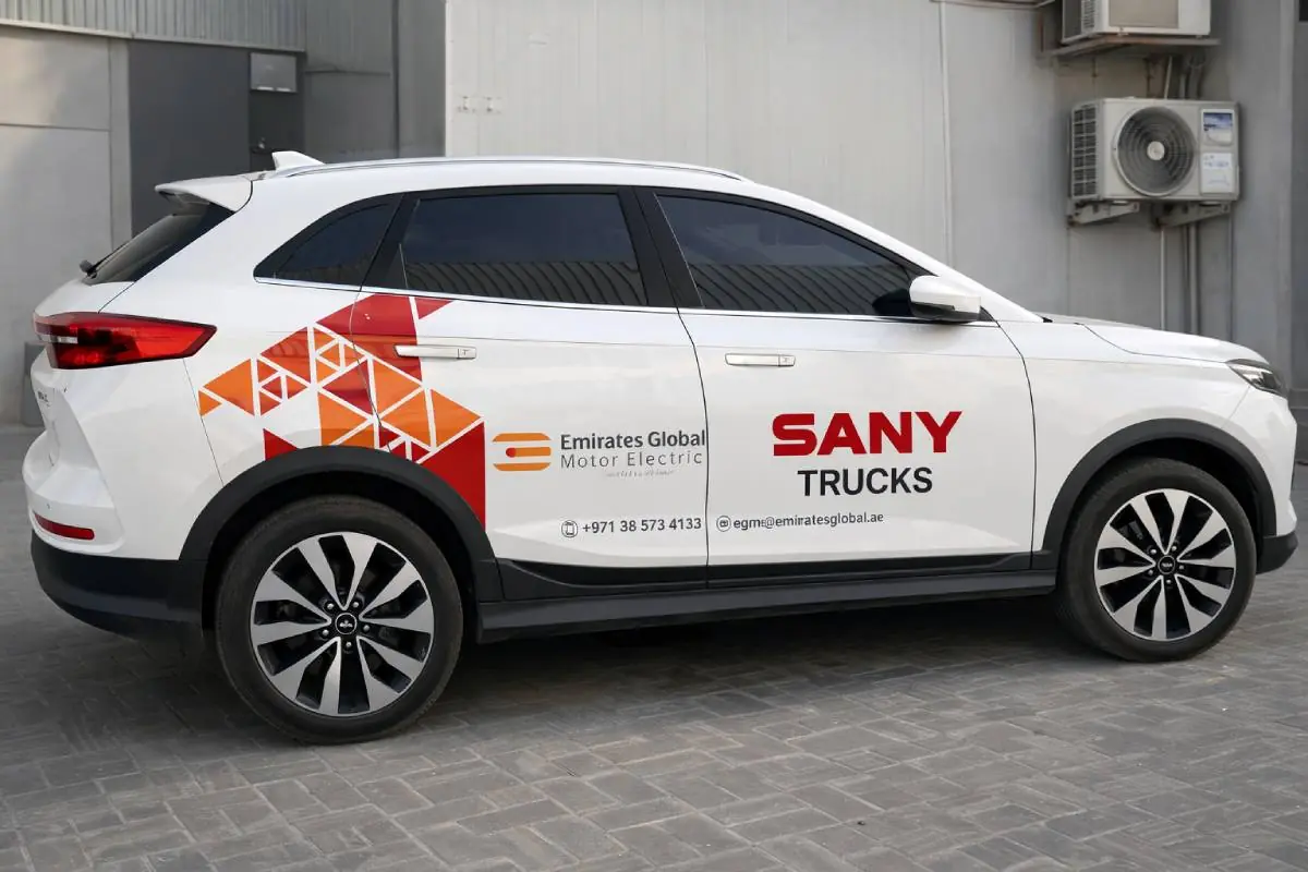 Emirates Global Motor Electric and SANY Trucks partial branding on a white SUV in Abu Dhabi