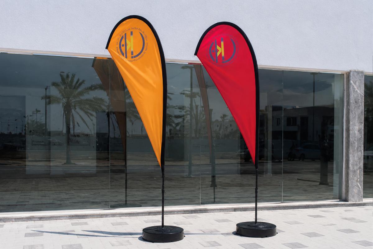 Al Bahri Design & Landscape Sail Flags in pink, white, and green in Saadiyat, Abu Dhabi by Ninety Nine Advertising LLC.