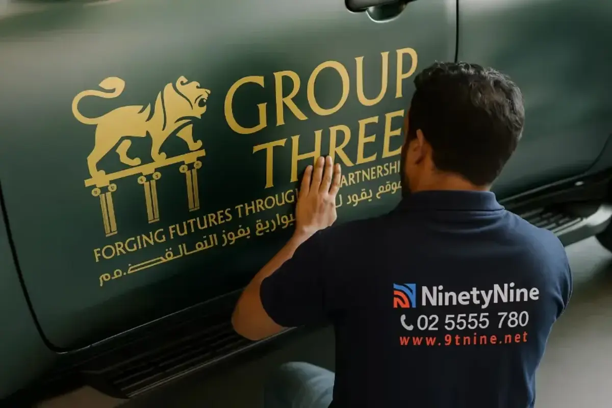 Group Three Gold cut vinyl fleet decals on a dark green pickup truck in Musaffah, Abu Dhabi