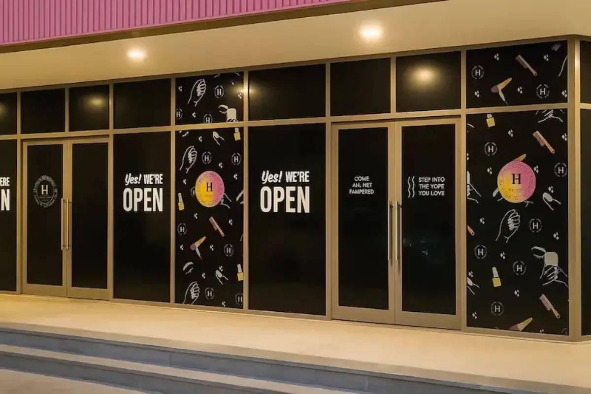Storefront window lettering and business information in Abu Dhabi